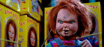 Chucky surrounded by Chucky dolls;