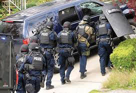 Officers with the Combined Forces Special Enforcement Unit of British Columbia en route to arrest a suspect;