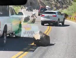Large rocks blocking traffic on HWY 395 to State Route 182 near the California-Nevada border town of Bridgeport ;