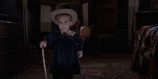 Pet Sematary Gage Dressed as Little Boy Blue with a Top Hat and A Kane;