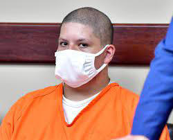 Joseph Jimenez sitting in an orange jumpsuit during court appearance;