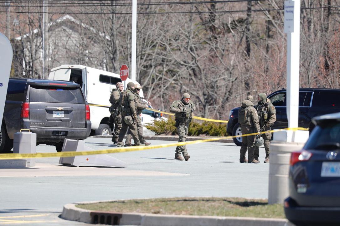 RCMP Officers standing outside a scene of the shooting caused by 51-year-old Gabriel Wortman;