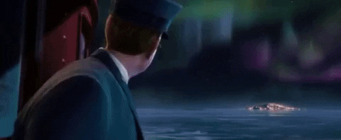 Polar Express Tom Hanks character pointing towards the aurora lights;