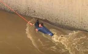 Young Man in the LA River trying to rescue Scooby the German Shepard Mix;